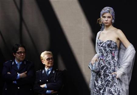 A model displays a creation of Giorgio Armani during a fashion show in San Vittore prison in Milan